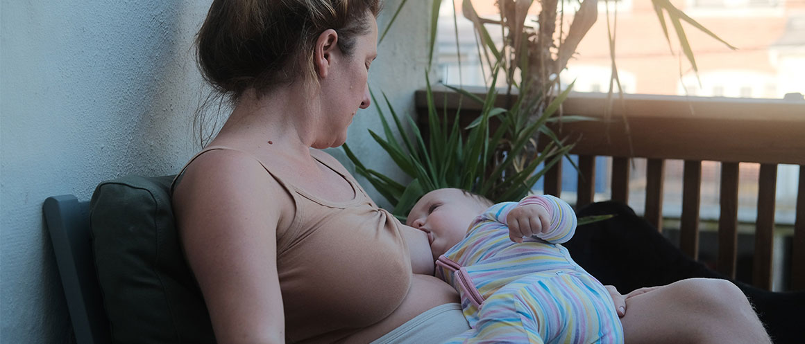 https://www.natracare.com/wp-content/uploads/2022/11/woman-breastfeeding-baby.jpg
