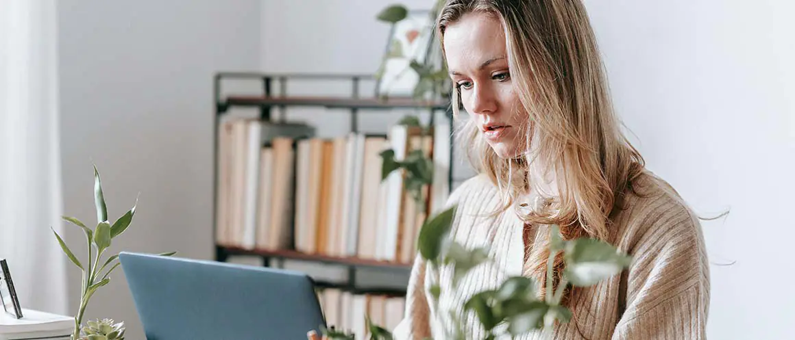 Woman concerned looking at laptop